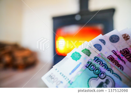 Heating payment. Save money wood stove. Russian ruble banknotes for payment of heating firewood. Heating payment. Save money wood stove. Russian ruble banknotes for payment of heating firewood. 137512098