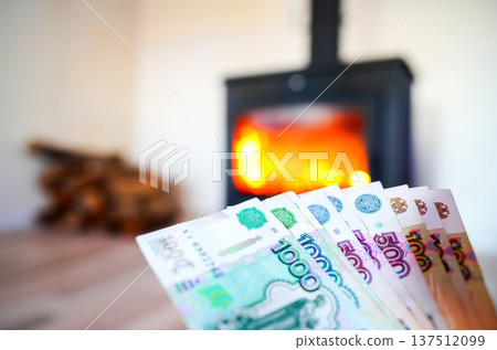 Heating payment. Save money wood stove. Russian ruble banknotes for payment of heating firewood. Heating payment. Save money wood stove. Russian ruble banknotes for payment of heating firewood. 137512099