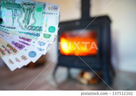 Heating payment. Save money wood stove. Russian ruble banknotes for payment of heating firewood. Heating payment. Save money wood stove. Russian ruble banknotes for payment of heating firewood. 137512102
