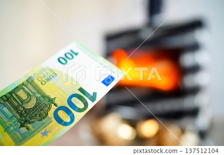 Heating payment. Save money wood stove. Euro money banknotes for payment of heating  137512104