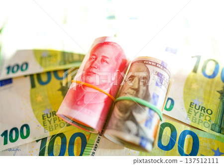 Chinese yuan, US dollars on Euro money Euro currency background. Chinese yuan, US dollars Chinese yuan, US dollars on Euro money Euro currency background. Chinese yuan, US dollars 137512111