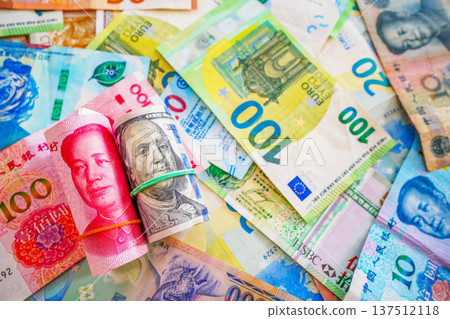 Chinese yuan, US dollars among various currencies background. Banknotes different countries Chinese yuan, US dollars among various currencies background. Banknotes different countries 137512118