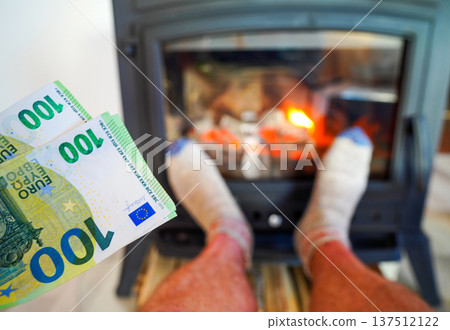 Heating payment. Save money wood stove. Euro money banknotes for payment of heating firewood Heating payment. Save money wood stove. Euro money banknotes for payment of heating firewood 137512122