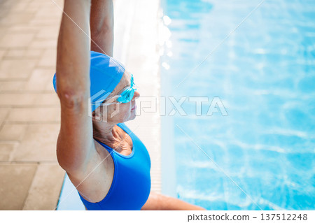 Senior woman getting ready for swim. Senior woman getting ready for swim. 137512248