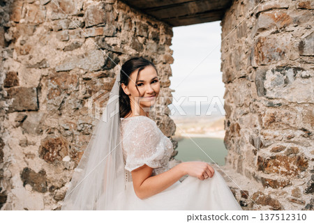 Stunning bride in a snow-white wedding dress with short sleeves. 137512310