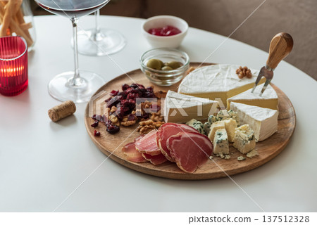 Charcuterie Board with Red Wine. Elegant Gourmet Gathering Charcuterie Board with Red Wine. Elegant Gourmet Gathering 137512328