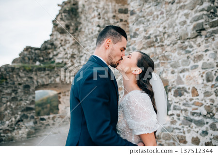 Portrait of husband kissing beautiful bride. Portrait of husband kissing beautiful bride. 137512344