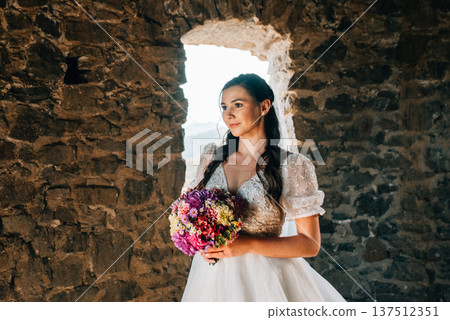 Stunning bride in a snow-white wedding dress with short sleeves. Stunning bride in a snow-white wedding dress with short sleeves. 137512351