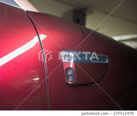 Cameras on the body of a red car.  137512470