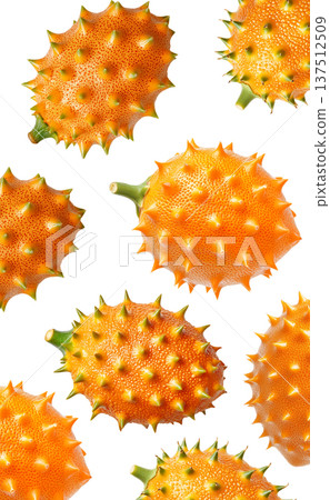 Multiple horned orange kiwano fruits with green tips isolated on white background, concept of exotic fruit freshness 137512509