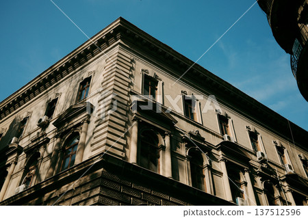 Low angle view of historic urban architecture with decorative facade and tall windows under a clear blue sky in Belgrade Low angle view of historic urban architecture with decorative facade and tall windows under a clear blue sky in Belgrade 137512596