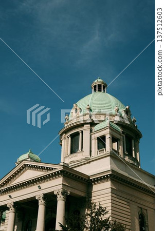 Close view of the green dome and classical architecture of the National Assembly building against a clear blue sky in Belgrade Close view of the green dome and classical architecture of the National Assembly building against a clear blue sky in Belgrade 137512603