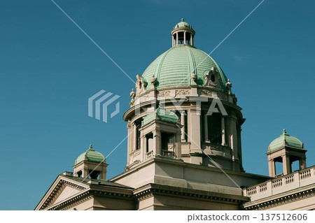 Close view of the green dome and classical architecture of the National Assembly building against a clear blue sky in Belgrade 137512606
