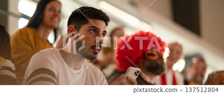 Worried football fans supproting German national team in live soccer match at stadium. Worried football fans supproting German national team in live soccer match at stadium. 137512804