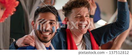 Excited football fans supproting French national team in live soccer match at stadium. Excited football fans supproting French national team in live soccer match at stadium. 137512812