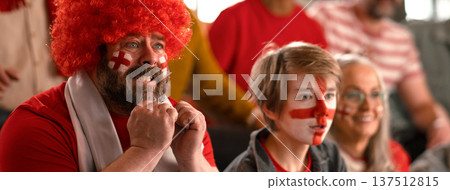 Excited football fans supproting English national team in live soccer match at stadium. Excited football fans supproting English national team in live soccer match at stadium. 137512815