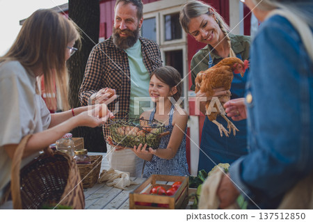 Buying organic produce and eggs at local farmers market. Buying organic produce and eggs at local farmers market. 137512850