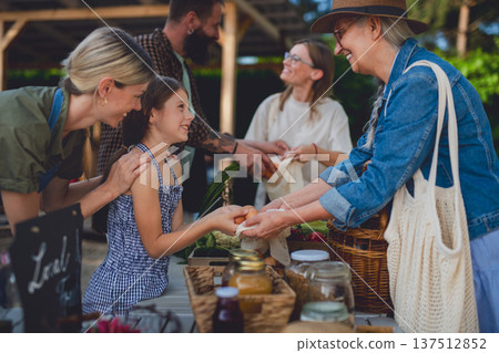 Buying organic produce and eggs at local farmers market. Buying organic produce and eggs at local farmers market. 137512852