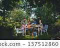 Happy farmer family looking at their harvest outdoors in garden. 137512860