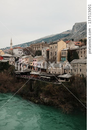Old town of Mostar with mosque, minaret, historic houses, and turquoise Neretva River. Cultural Balkan cityscape representing history, religion, and travel heritage Old town of Mostar with mosque, minaret, historic houses, and turquoise Neretva River. Cultural Balkan cityscape representing history, religion, and travel heritage 137513001
