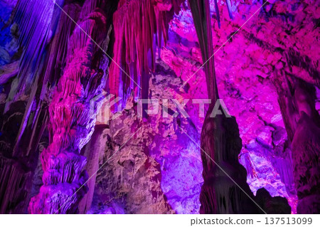Brightly lit cave formations in Gibraltar show colorful displays, highlighting unique geology and nature's artistry 137513099