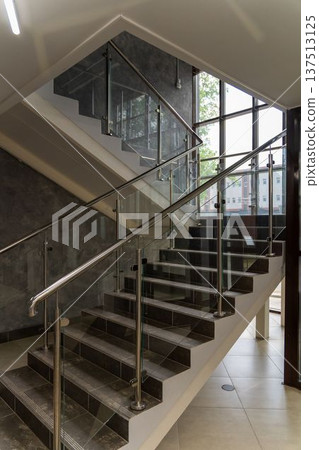 Modern staircase with dark stone steps Modern staircase with dark stone steps 137513125