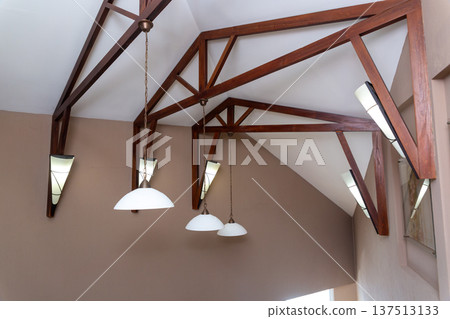 Modern interior ceiling featuring decorative dark wooden beams Modern interior ceiling featuring decorative dark wooden beams 137513133