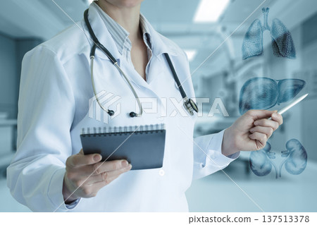 Doc reviewing health data 137513378