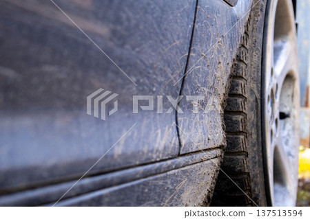 Dirt sticks to the side of a car after driving through muddy areas in the countryside in the late afternoon light Dirt sticks to the side of a car after driving through muddy areas in the countryside in the late afternoon light 137513594