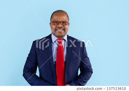 Portrait of mature black businessman wearing glasses and suit on studio background 137513618