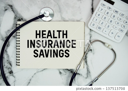 Health Insurance Savings text written on notepad with stethoscope and  calculator on marble background 137513708