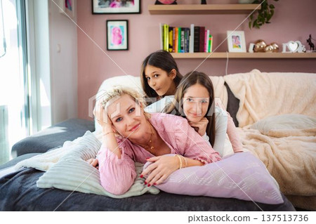 Happy mother and two daughters spending time together 137513736