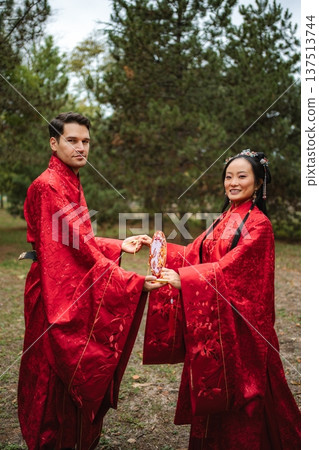 Couple celebrating intercultural wedding in traditional Chinese attire 137513744