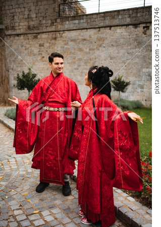 Multicultural couple celebrating marriage in traditional Chinese attire 137513746