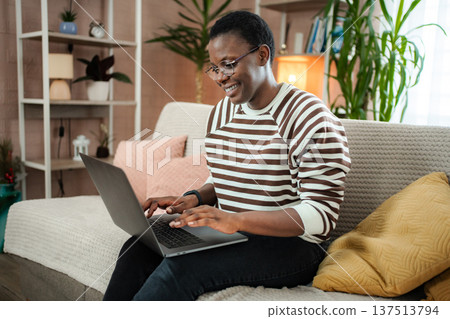 Young adult woman working from home on laptop 137513794