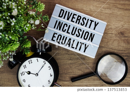 Diversity Inclusion Equality text in lightbox with magnifying glass and alarm clock flat lay on wooden background Diversity Inclusion Equality text in lightbox with magnifying glass and alarm clock flat lay on wooden background 137513853