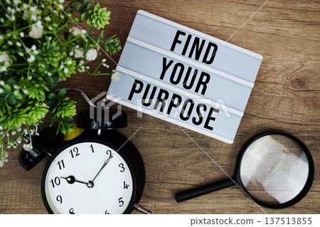 Find Your Purpose text in lightbox with magnifying glass and alarm clock flat lay on wooden background Find Your Purpose text in lightbox with magnifying glass and alarm clock flat lay on wooden background 137513855