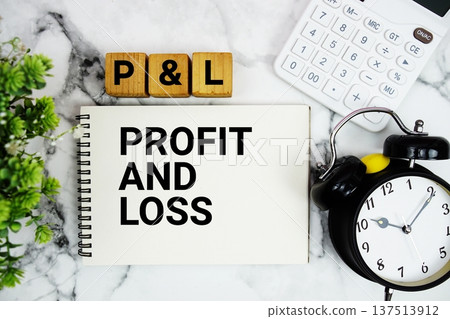 PAL Profit And Loss text with calculator and alarm clock on marble background 137513912