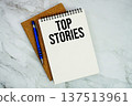 Top Stories text written on notepad with pen on marble background 137513961