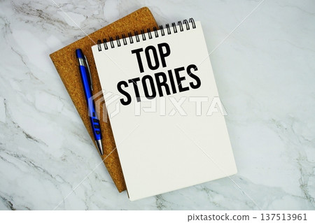 Top Stories text written on notepad with pen on marble background 137513961