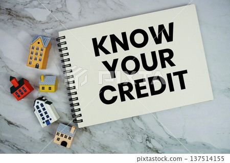 Know Your Credit text written on notepad with house model on marble background 137514155