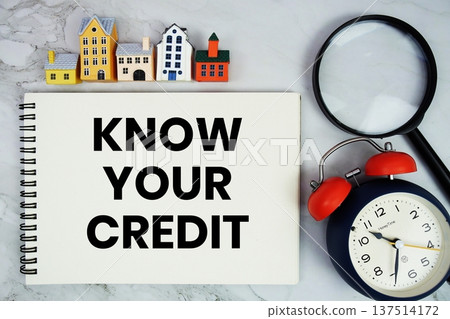 Know Your Credit text written on notepad with house model, magnifying glass and alarm clock on marble background Know Your Credit text written on notepad with house model, magnifying glass and alarm clock on marble background 137514172