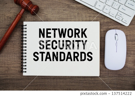 Network Security Standards text written with gavel, keyboard and optical mouse on wooden background Network Security Standards text written with gavel, keyboard and optical mouse on wooden background 137514222
