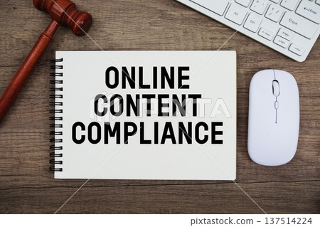 Online Content Compliance text written with gavel, keyboard and optical mouse on wooden background 137514224