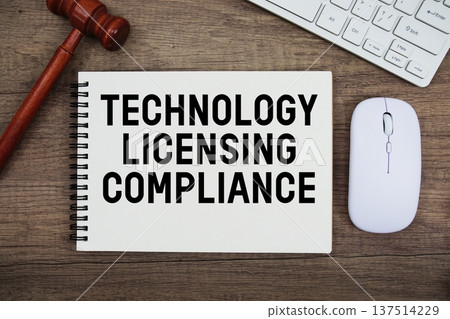Technology Licensing Compliance text written with gavel, keyboard and optical mouse on wooden background 137514229