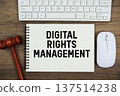 Digital Rights Management text written with gavel, keyboard and optical mouse on wooden background 137514238
