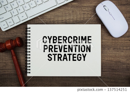 Cybercrime Prevention Strategy text written with gavel, keyboard and optical mouse on wooden background 137514251