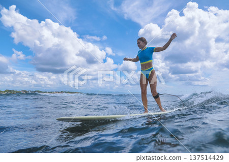 Female Wave Rider Perfects Maneuvers During Sunlit Surf Practice Session 137514429