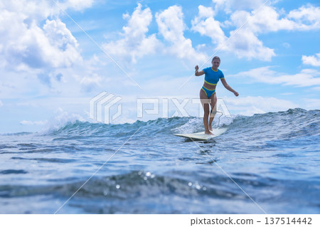 Woman Sharpens Her Longboard Talents Beneath Clear Skies And Remote Islands Woman Sharpens Her Longboard Talents Beneath Clear Skies And Remote Islands 137514442
