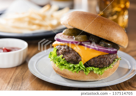 Cheeseburger and fries fast food on wooden table Cheeseburger and fries fast food on wooden table 137514705
